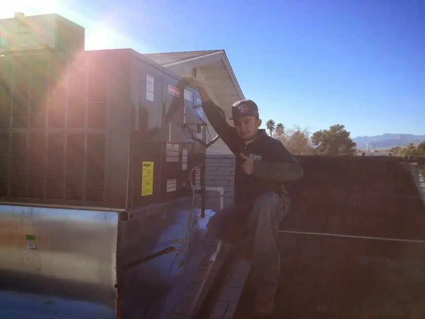 HVAC technician performing HVAC Inspection on a rooftop unit in Boiling Spring Lakes